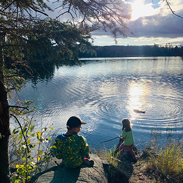 Two students fishing in a lake