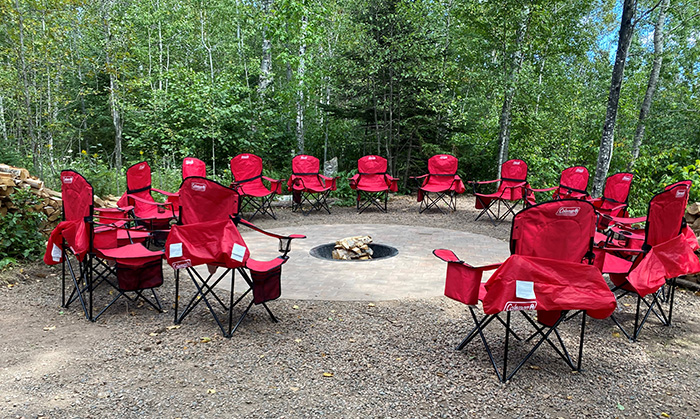 Camp chairs in circle around campfire