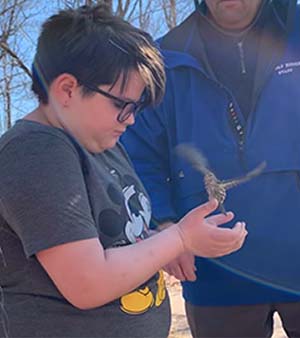 Child holding hummingbird