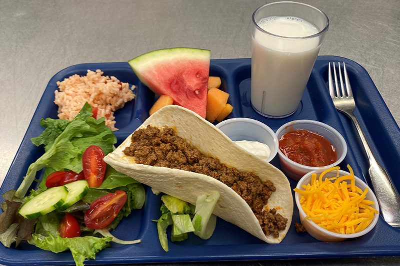 Soft Shell Tacos, Spanish rice, green salad, fruit, and glass of milk
