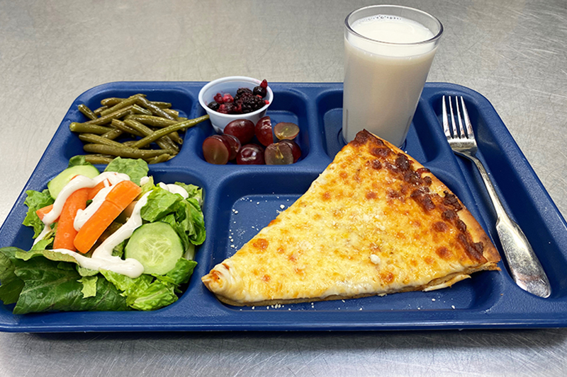 Salad, slice of cheese pizza, green beans, grapes, and milk