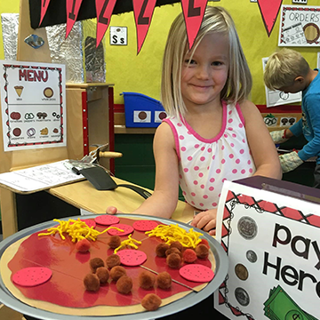 Girl holding a craft fake pizza