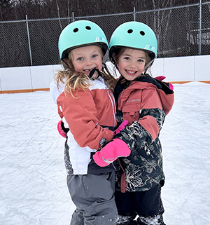 Two happy girls hugging each other for a photo