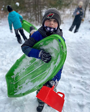 Boy with a sled in the snow