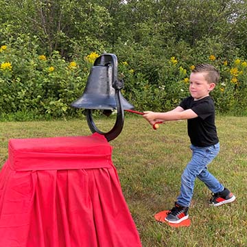 Young student with a bell