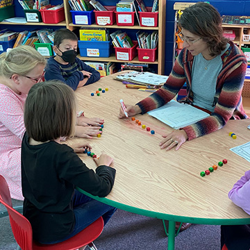 Teacher with students at a table