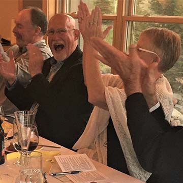 Happy Gala participants sitting at a dinner table