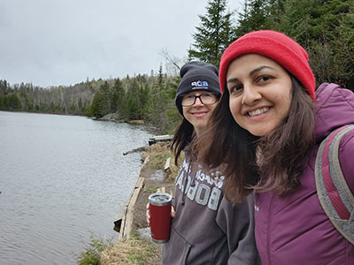 Two ladies smiling by the lake